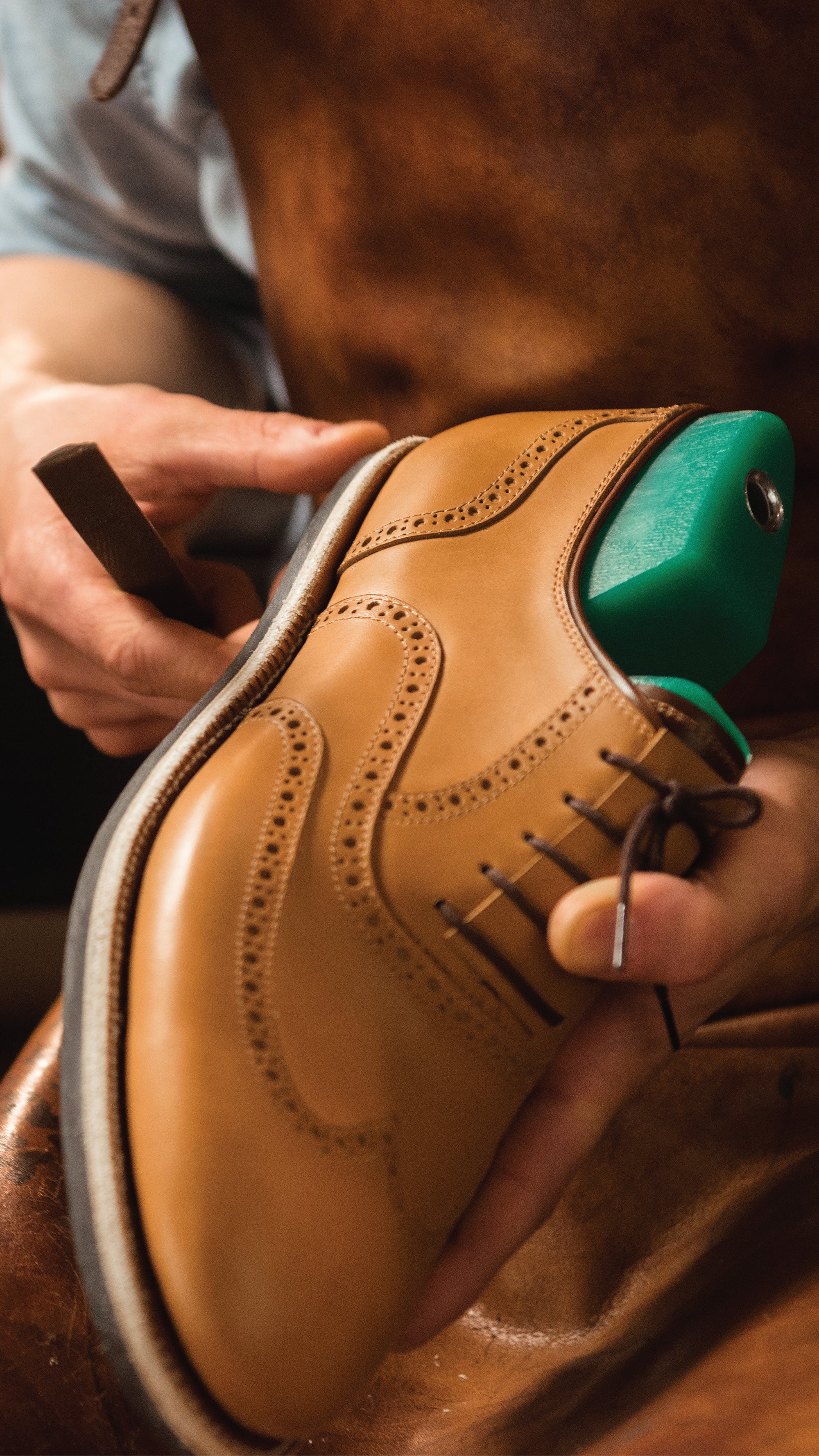 Shoe and Boot repair image - Dardano's Employee preparing a shoe for repair